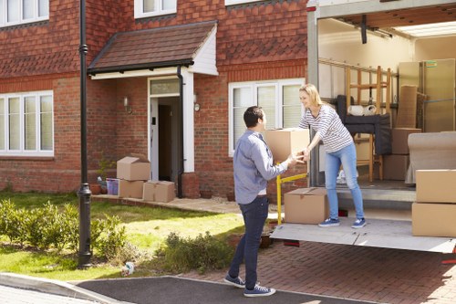 Removal team preparing furniture for transport in a residential street