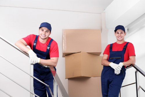 Van crew securing furniture with safety straps during transport