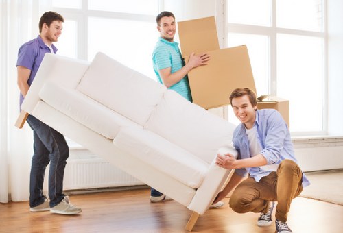 Local removals crew handling boxes and furniture