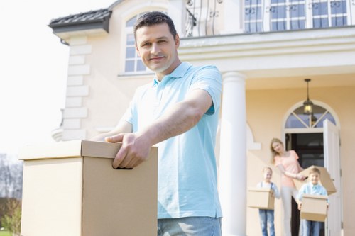 Professional movers handling packed boxes and furniture